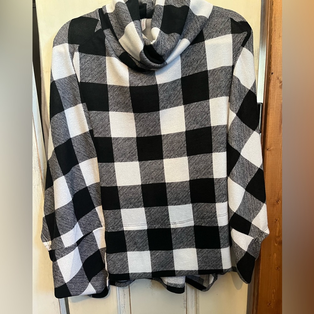 Poncho style shirt, mock neck with sleeves and pockets.
